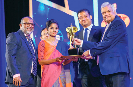 President Ranil Wickremesinghe and State Minister Dilum Amunugama present the Exporter of the Year Award for 2022/23 to CEO, MAS Kreeda, Ziyan Zahir and Team Member, Sewing at MAS Kreeda, Buddhini Gayanthi. Pic: Sulochana Gamage