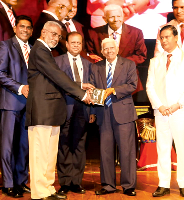 The author presenting the book to Premasara Epasinghe.