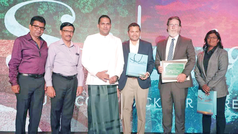 Minister Harin Fernando and Sri Lanka Tourism officials with the team that contributed to win the award