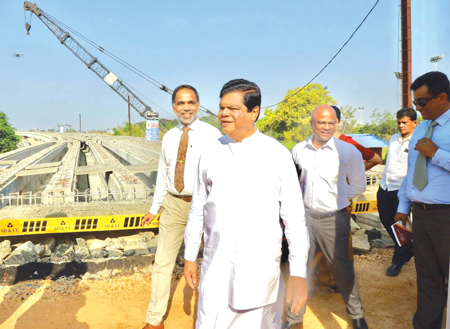 Minister Dr. Bandula Gunawardena, Colombo district MP Madura Vithanage and Chairman, State Development and Construction Corporation, Kushan Devinda 
inspect the construction work