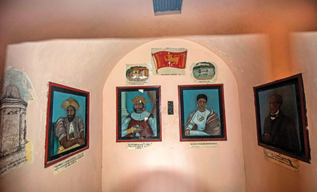 The inside wall of the cell is decorated with paintings and portraits of the King, queen and other key figures