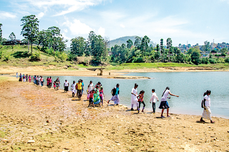 Sri Pada pilgrims on their way to the reservoir-bed of Moussekelle during drought