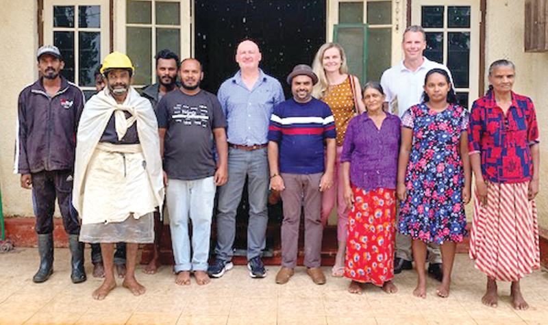Tharanga Muramudali (centre) with a tour group and coffee farmers