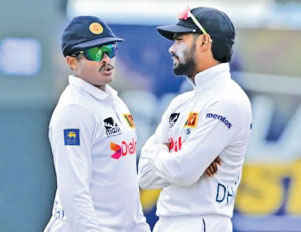Heads dropping! Sri Lanka captain Dhananjaya de Silva (right) and Jeffrey Vandersay hoping that something could happen