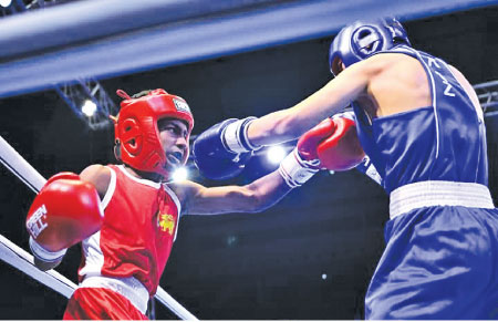 Sri Lanka’s Weliketiye Gedara Warnakulasooriya (Red) in action