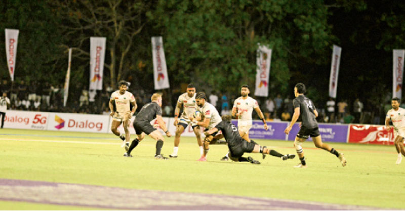 Sri Lanka flanker Nizran Nillar is tackled by a New Zealand defender (Pix by Hirantha Gunathilaka)