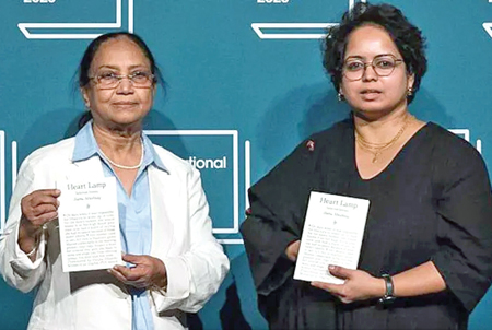 Banu Mushtaq (left) and Deepa Bhasthi (right) hold copies of Heart Lamp.