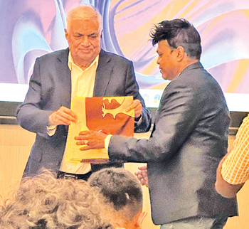 Receiving the National Flag from former President Ranil Wickremesinghe