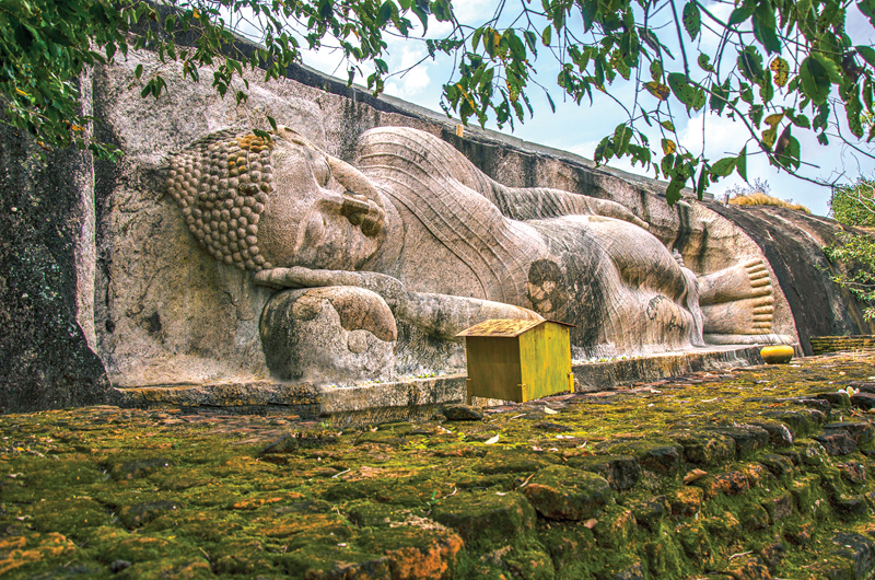 The reclining Buddha statue hewn into a rock