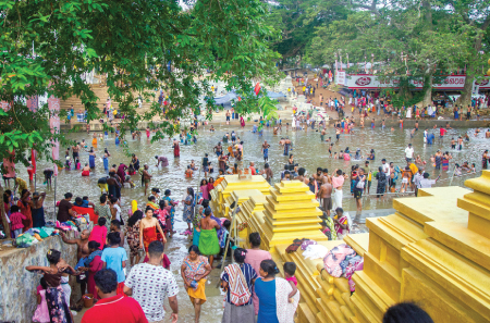 Pada Yatra pilgrims bathe in the Menik Ganga at Kataragama